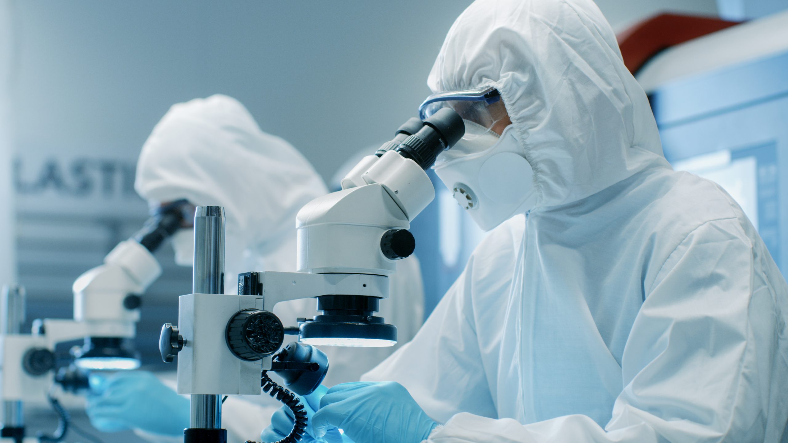 Two,Engineers/,Scientists/,Technicians,In,Sterile,Cleanroom,Suits,Control,Manufacturing